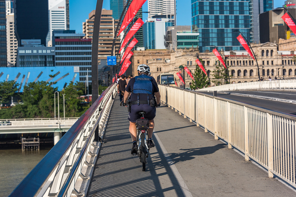 Person riding a bike over a bridge.